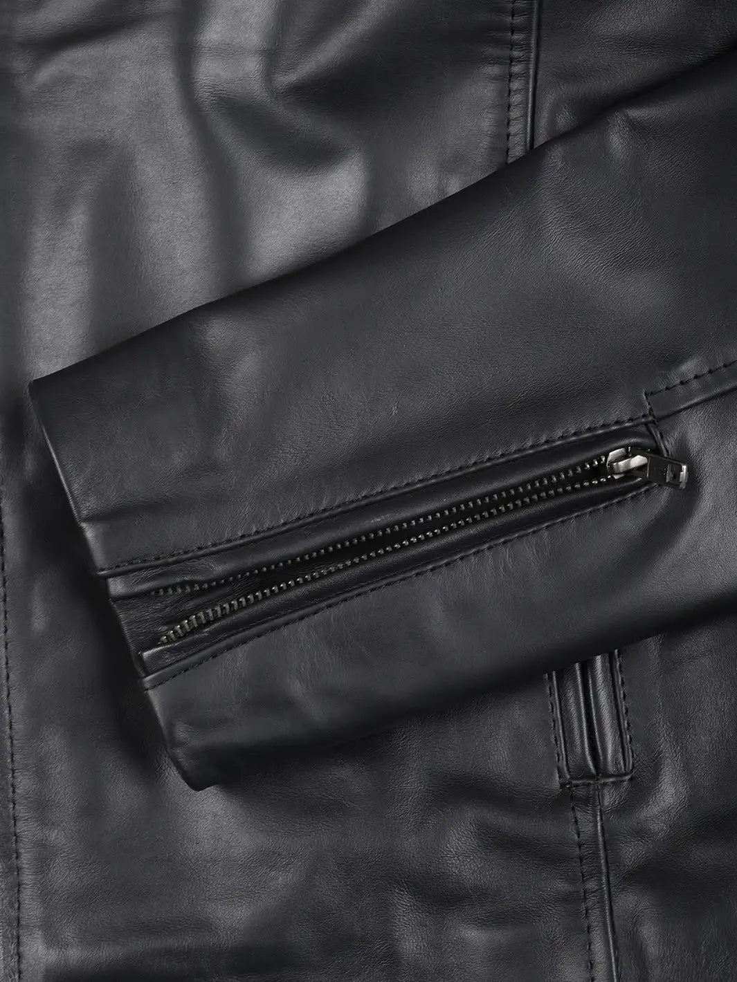 Close-up of a black leather jacket with a zipper