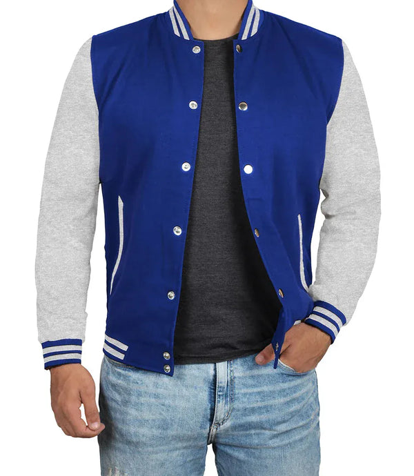 Blue varsity jacket with gray sleeves worn by a person on a white background