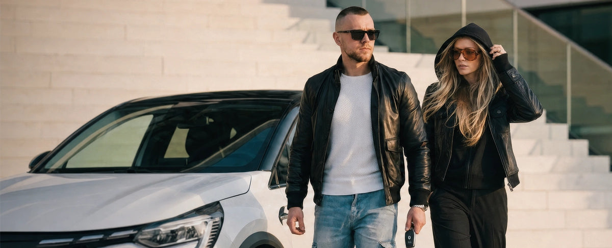 Man and woman in black real leather jackets outside a modern building